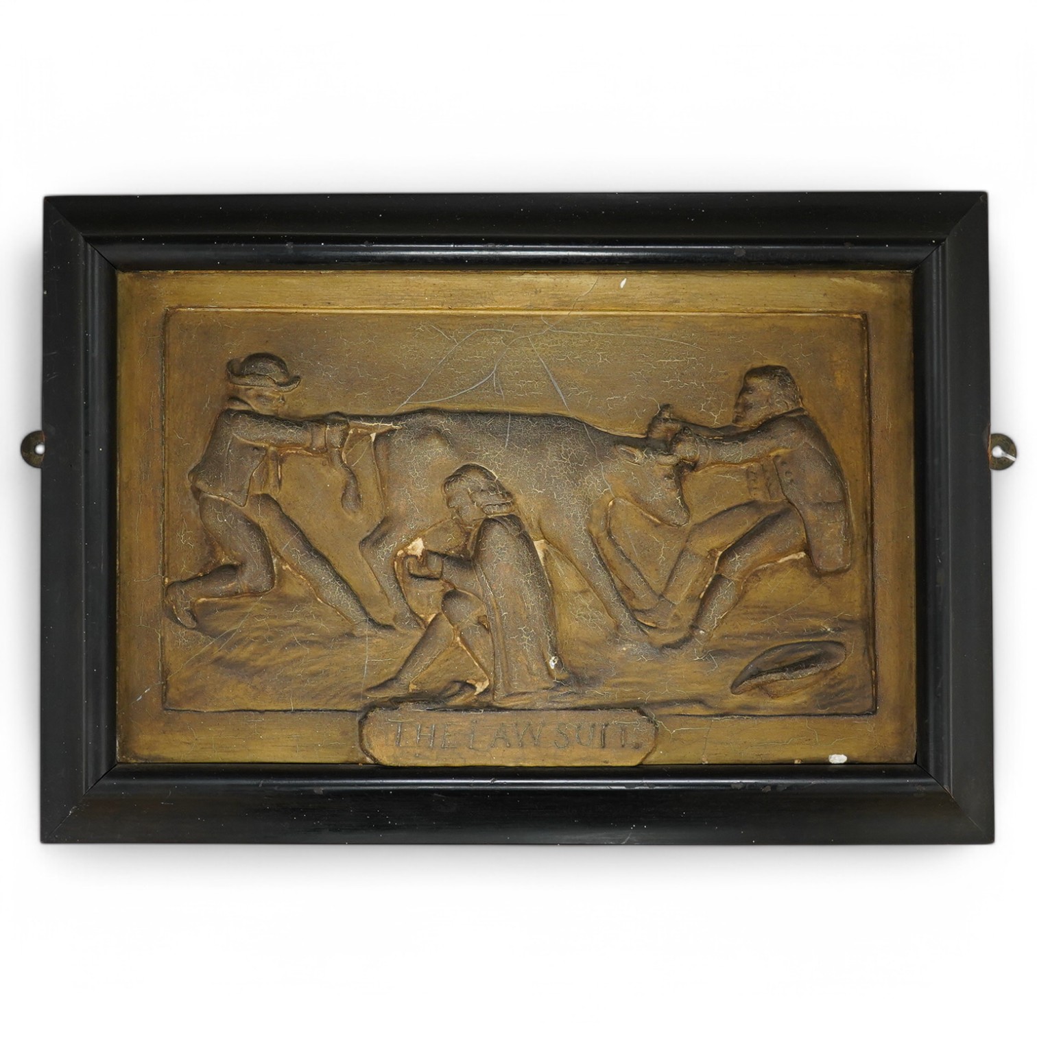 A framed 'The Lawsuit' painted plaster plaque, plaque 34cm wide x21.5cm high. Condition - crazing to painting